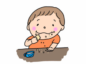 食べかすをたくさん落としている男の子